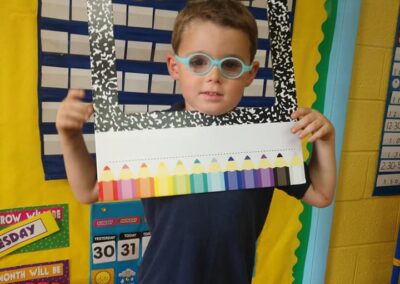 Student holds up First Day of School sign