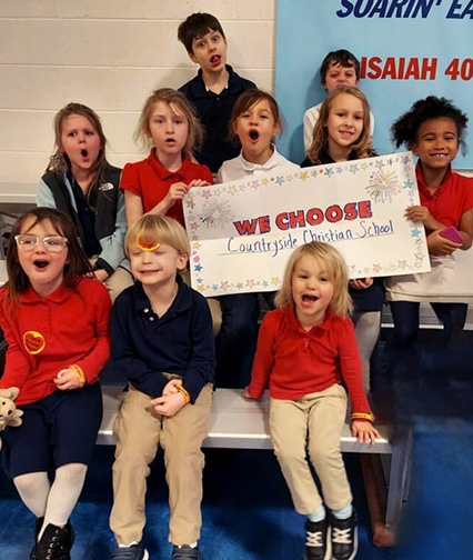 Group of students holding a "We Choose Countryside" poster