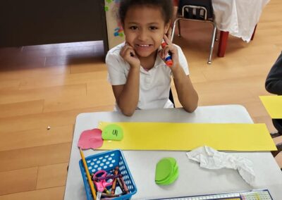 little girl sitting at her desk