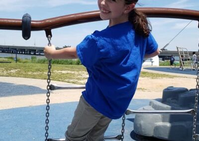 Student climbs on play equipment outside