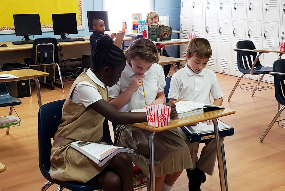 students sitting at a desk learning