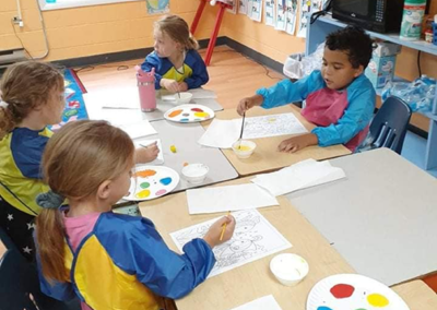 Students painting with smocks